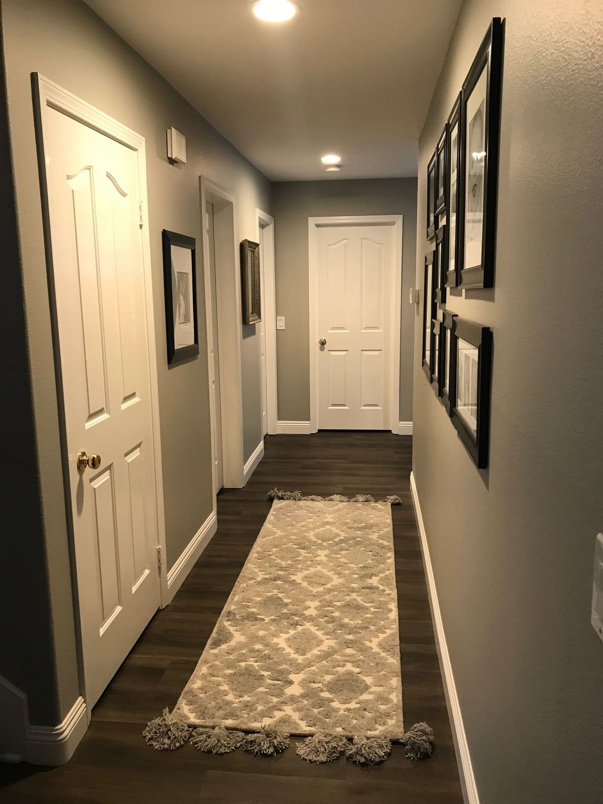 A safely lit hallway with a secured rug and nightlight